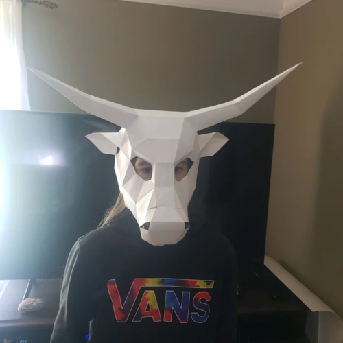 Kid with bull mask made of cardboard
