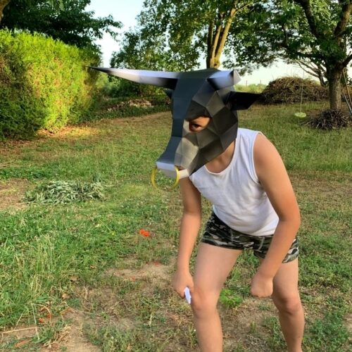 Child with bull mask made of cardstock