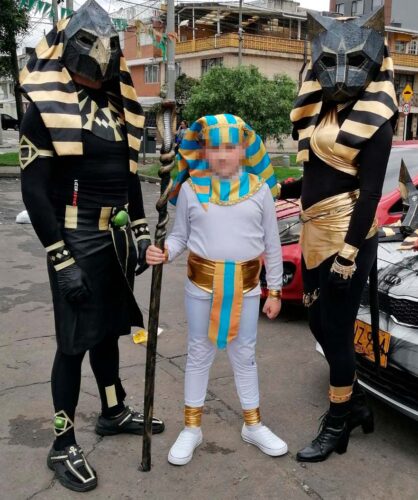 Adults in homemade Egyptian god costumes and a child dressed as a pharaoh